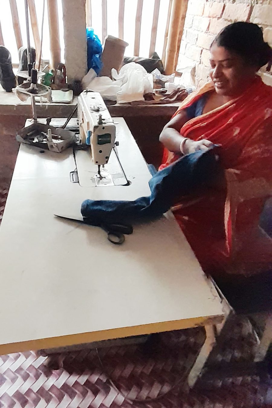 Jharna Sardar at her tailoring machine